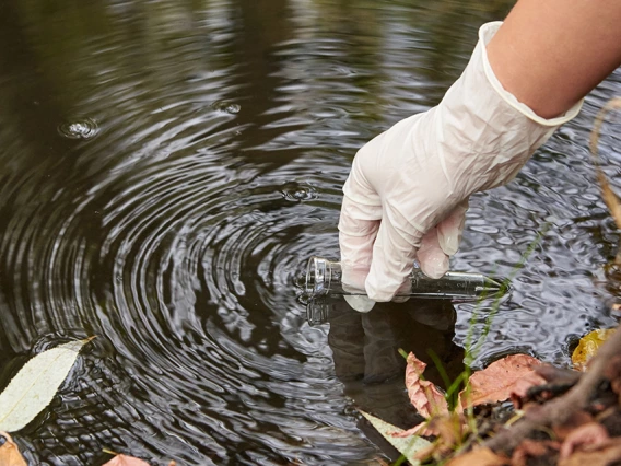 lead image of a scientist sampling water