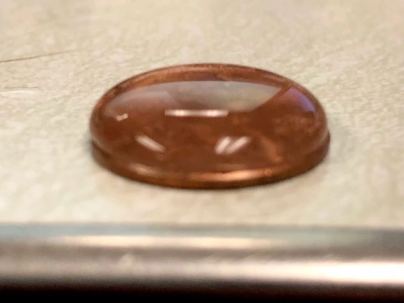 penny covered with water droplets