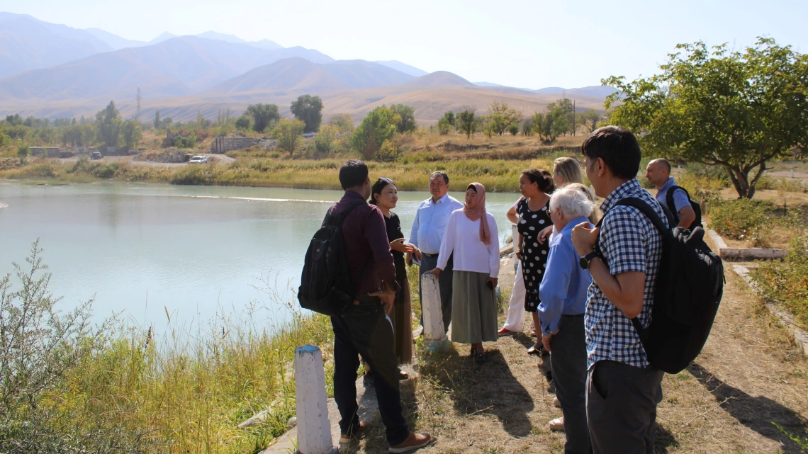 students standing near water