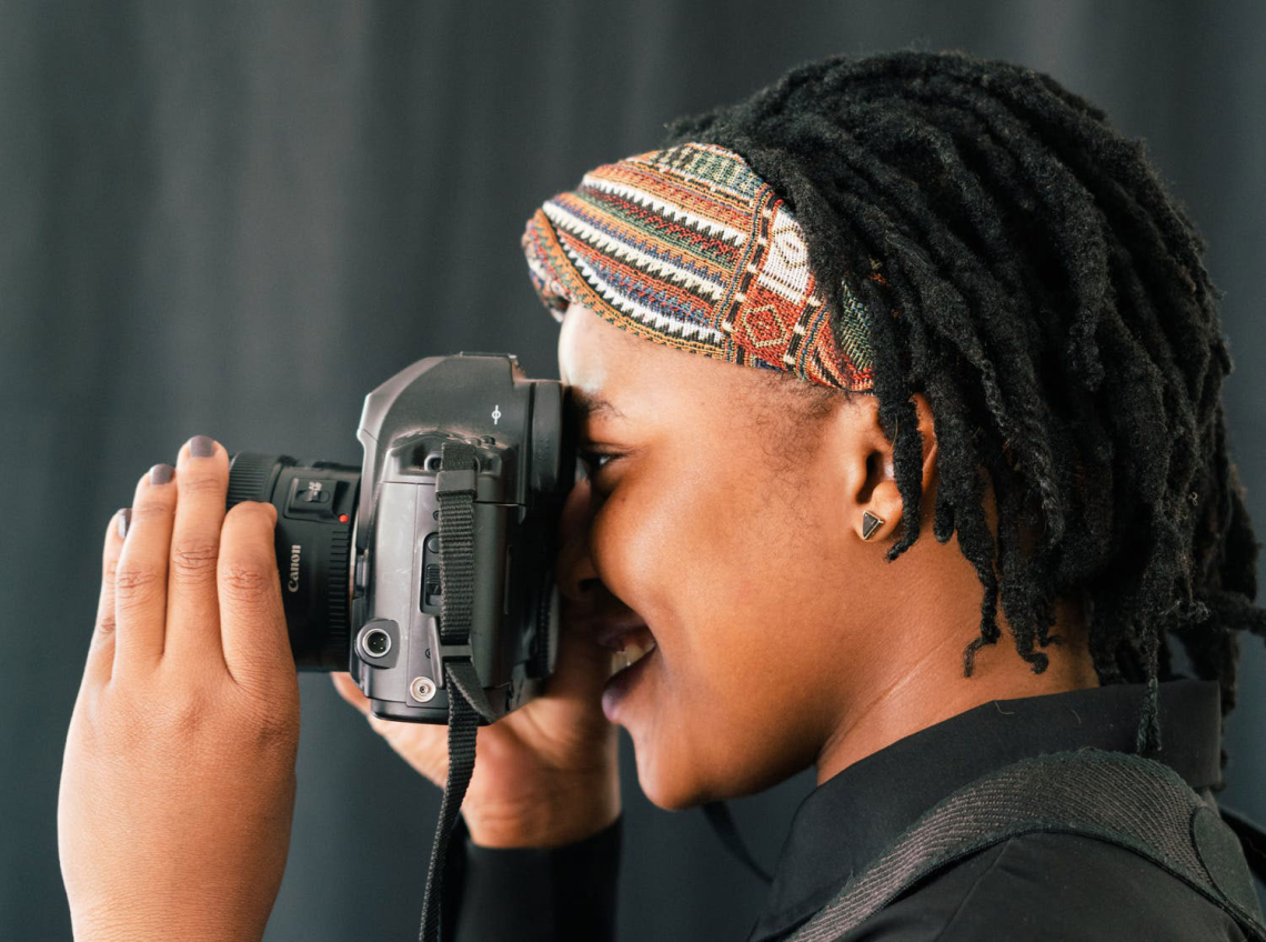 An individual focusing a camera